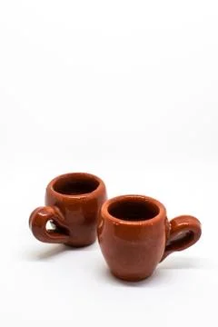 Tiny iconic brown hot chocolate mugs isolated on a white background Stock Photos