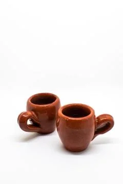 Tiny iconic brown hot chocolate mugs isolated on a white background Stock Photos