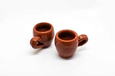 Tiny iconic brown hot chocolate mugs isolated on a white background Stock Photos