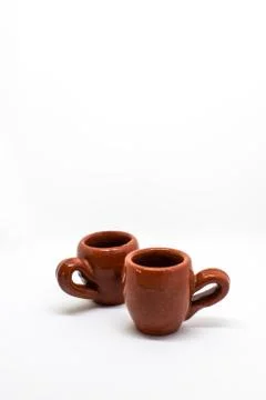 Tiny iconic brown hot chocolate mugs isolated on a white background Stock-Fotos