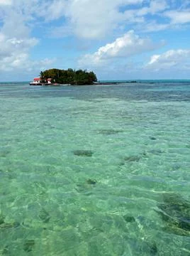 Tiny idyllic isle off coast of Mauritius with transparent Indian Ocean Stock Photos
