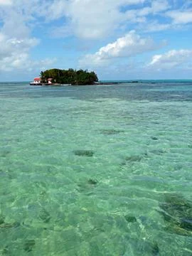 Tiny idyllic isle off coast of Mauritius with transparent Indian Ocean Stock Photos