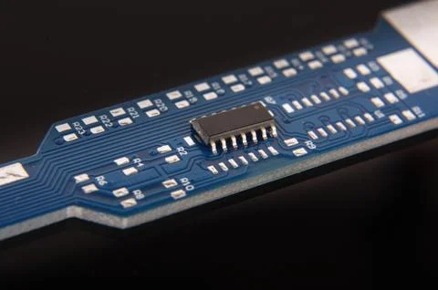 Tiny integrated circuit on empty PCB board Stock Photos
