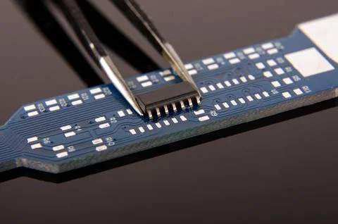 Tiny integrated circuit on empty PCB board 스톡 사진