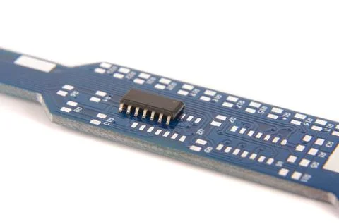 Tiny integrated circuit on empty PCB board Stock Photos