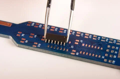 Tiny integrated circuit on empty PCB board 스톡 사진