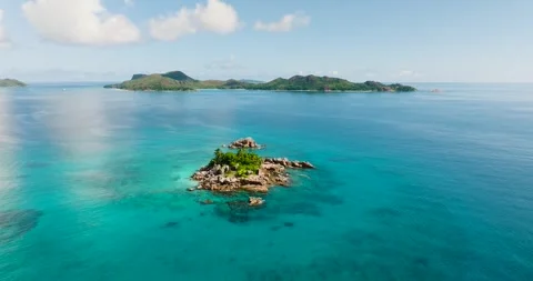 Tiny island amidst a vast blue ocean. Seychelles. Stock Footage 302262837