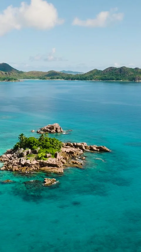 Tiny island amidst a vast blue ocean. Seychelles. Stock Footage 313510797
