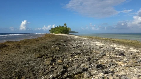 Tiny island on the coral rim of a remote pristine atoll. Tuvalu. Stock Footage 104919043