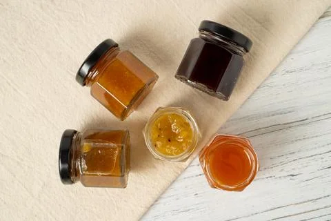 Tiny jam jars. Mini jars of jam. Different fruit jams in glass bottles 写真素材