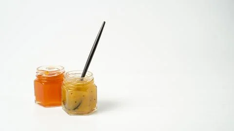 Tiny jam jars on white background. Mini jars of jam. Different fruit jams in  写真素材