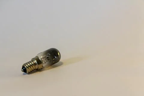 Tiny light bulb isolated on the white background Stock Photos