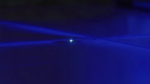 Tiny light emitting diode shining on blue surface 스톡 동영상 316540411