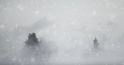 Tiny lighthouse and a tree in a snow storm Stock Photos