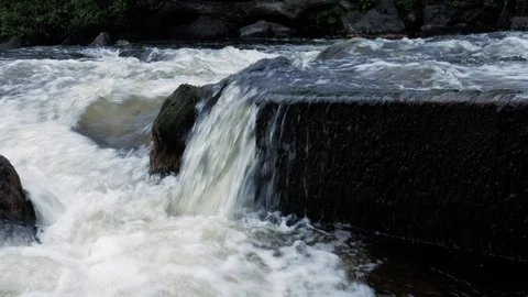 A tiny low waterfall, with clean fresh water of a river, falling from Stock Footage 110257101