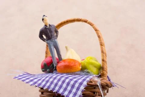 Tiny man figurine on a wicker basket 库存照片