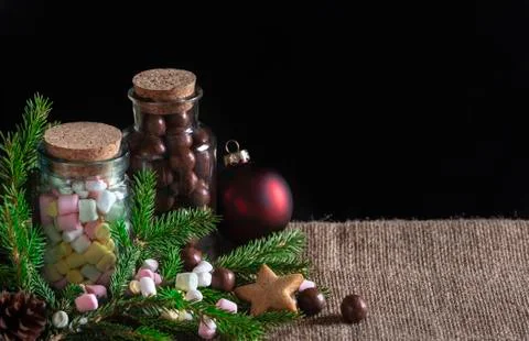 Tiny marshmallows and chocolate candy bottles Stock Photos