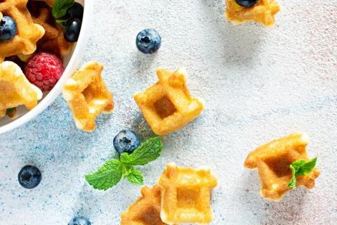 Tiny (Mini) waffles waffles with berries in a white bowl Stock Photos