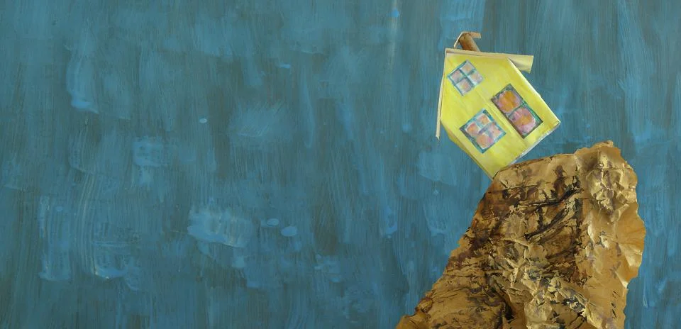 Tiny model home falls from a cliff, rising costs,inflation,energy crisis Stock Photos