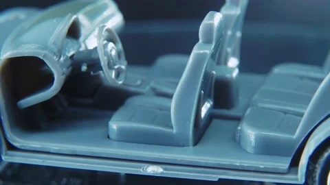 A tiny model metal sample skeleton of a car on a rotating stand with Stock Footage 231941126