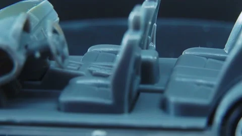 A tiny model metal sample skeleton of a car on a rotating stand with Stock Footage 231941752