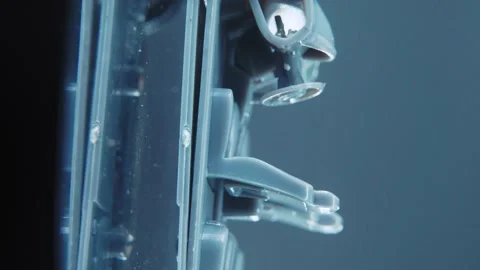 A tiny model metal sample skeleton of a car on a rotating stand with Stock Footage 231942484