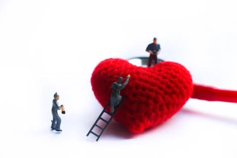 Tiny model take care red heart with stetroscope on isolated background Stock Photos