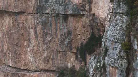 Tiny monastery on vast vertical cliff showing extreme scale, Tzoumerka, Epirus, 库存影片 341871666