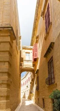 Tiny narrow empty street in Mdina Stock Photos
