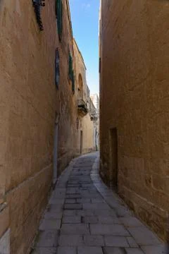 Tiny narrow empty street in Mdina Stock Photos