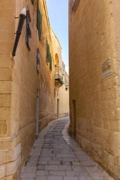 Tiny narrow empty street in Mdina Stock Photos