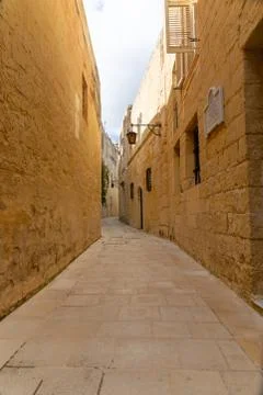 Tiny narrow empty street in Mdina Stock Photos