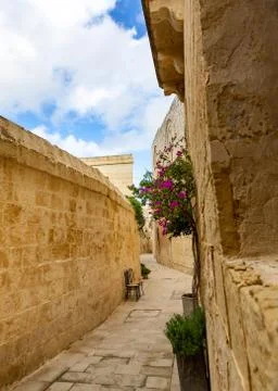 Tiny narrow empty street in Mdina Stock Photos
