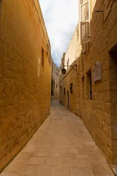 Tiny narrow empty street in Mdina Stock Photos