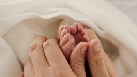 Tiny newborn feet in mother hands Stock Footage 164901970
