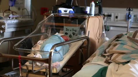 Tiny newborn sleeping by his mother in hospital dolly shot Video stock 44524589