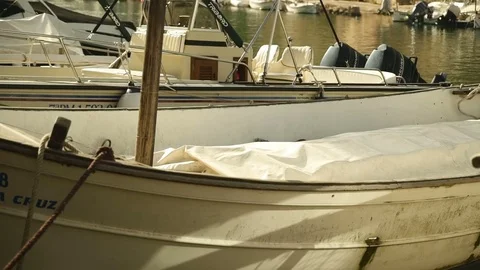 A tiny nice white boat on a sunny day in a harbour in Mallorca Video stock 81214094