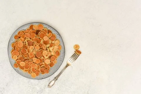 Tiny pancake cereal on light background with copy space. Foto stock