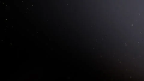 Tiny particles floating in a deep black background 스톡 동영상 315678406
