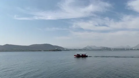 Tiny passenger cruise boat sails in the Lake Pichola. Udaipur, Rajasthan, India Stock Footage 229817755
