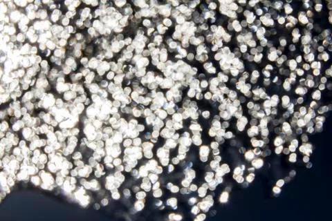 Tiny patches of light shining through dark surface Stock Photos