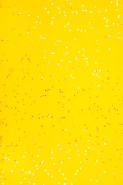 Tiny pearl stars on yellow background. Foto stock