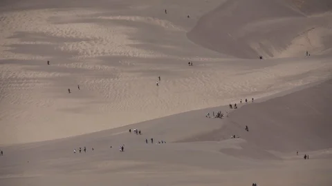 Tiny people hurry across giant sand dunes timelapse Stock Footage 107622062
