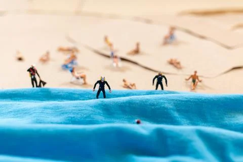 A tiny person in a diving suit on the beach in the summer Stock Photos