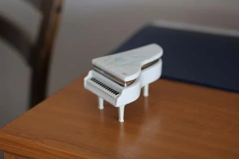 Tiny piano on a desk Stock Photos