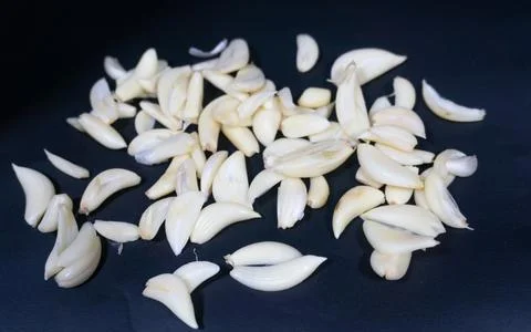 Tiny pieces of garlic cloves in the black background Stock Photos