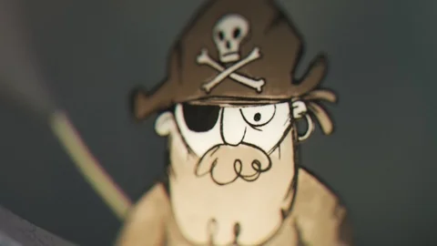 A tiny pirate character made out of paper commanding his ship to attack. 4KHD Stock Footage 110133061