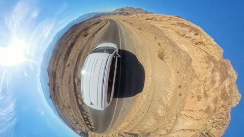 Tiny Planet 360 aerial view of a car skillfully driving along a winding road Stock Footage 306038324