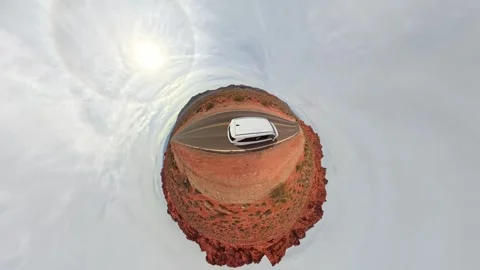 Tiny planet aerial view of white van on desert road with stunning rock Stock Footage 306039259