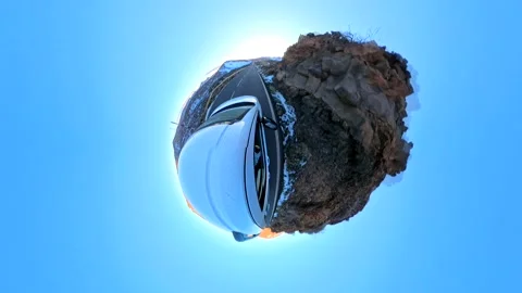 "Tiny Planet" effect of a car driving through the outskirts of Tenerife Stock Footage 297889042